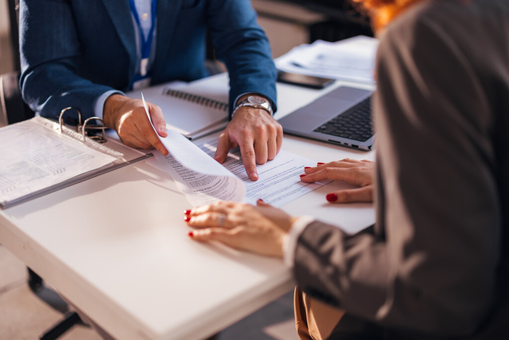 Lender and borrower reviewing multifamily bridge loan documents during underwriting